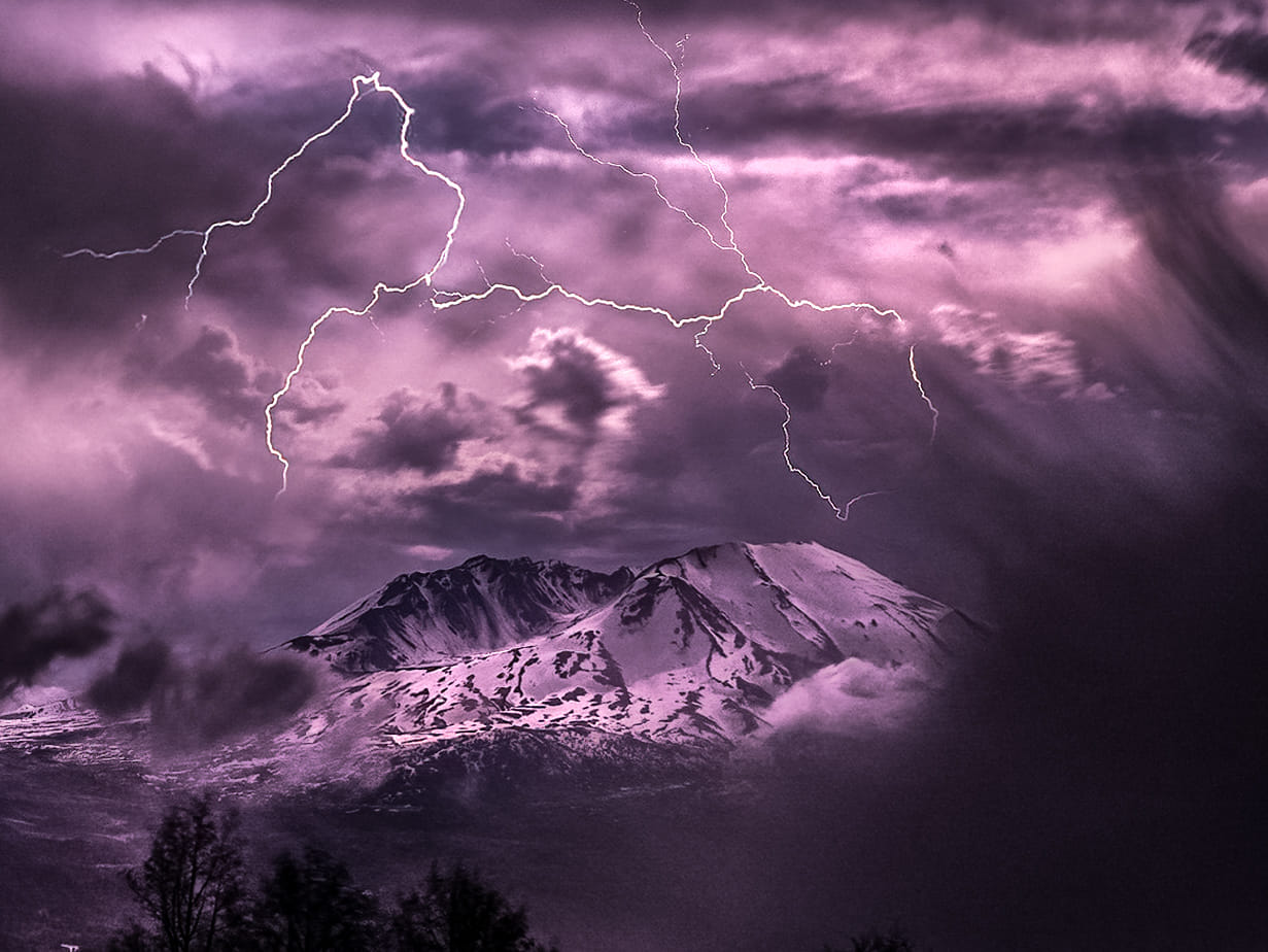 Mt St Helens lit up with a purple tint