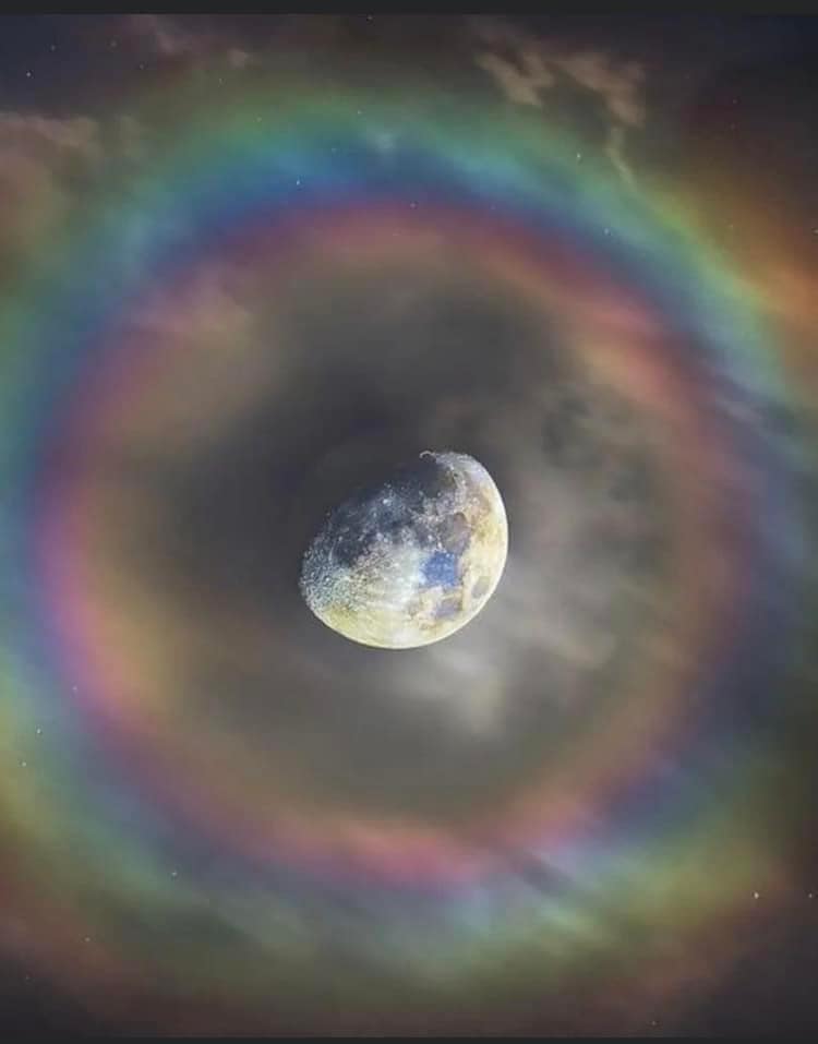  the moon surrounded by a rainbow