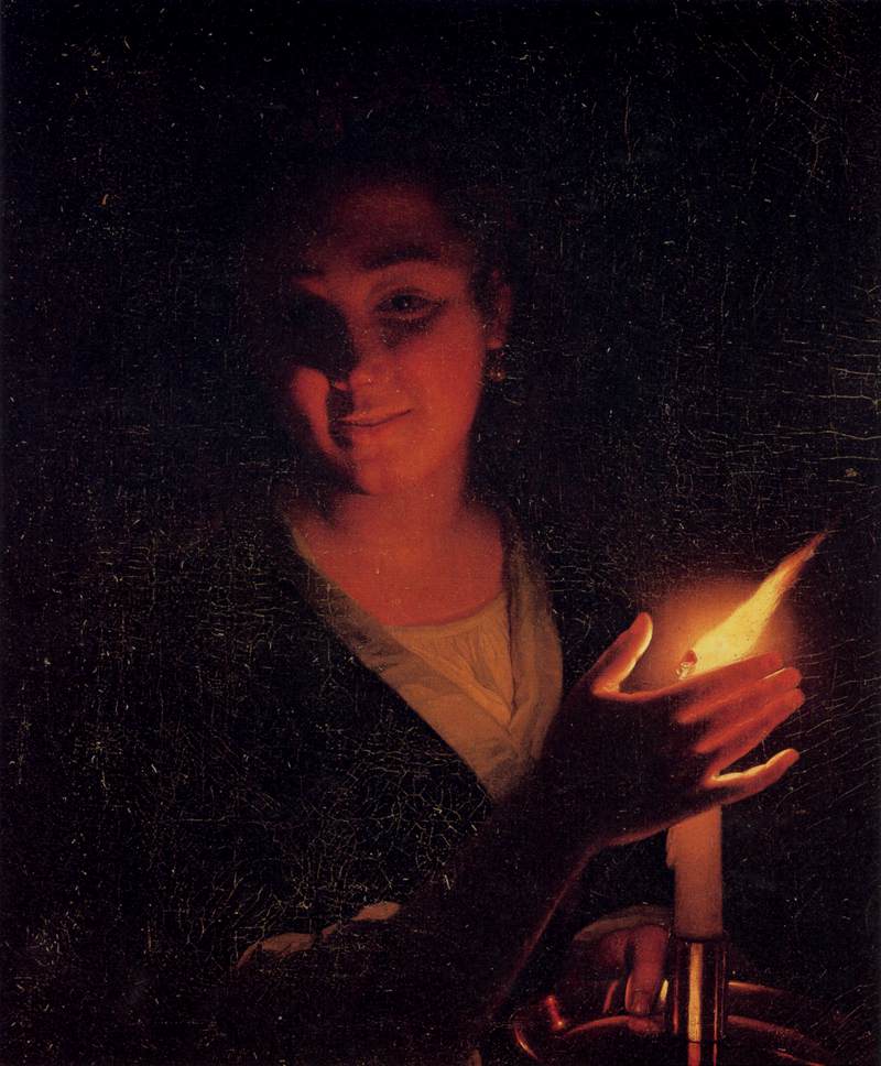 A young woman with a burning candle