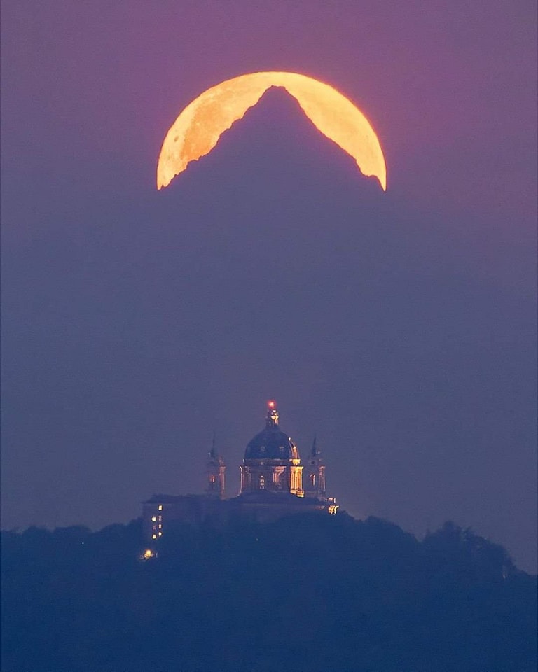The full moon behind Mount Monviso and the Basilica of Superga